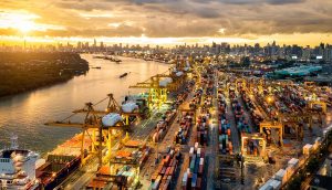 Aerial view of international port with Crane loading containers.