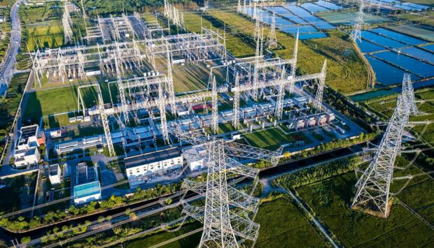 Aerial view of electricity pylons and an electrical substation