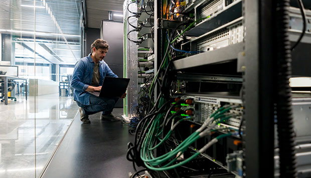 A person inspecting wiring and cables